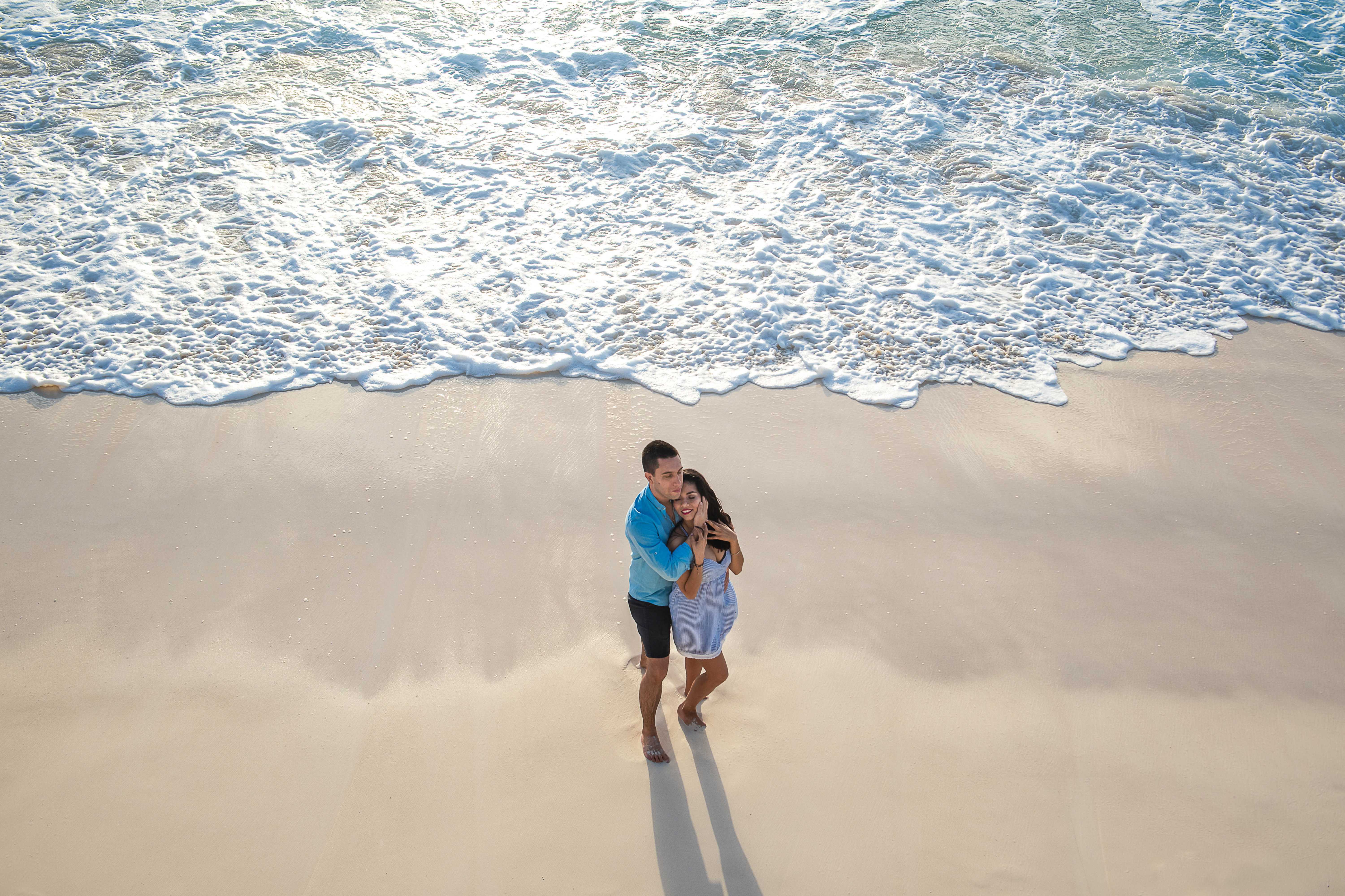 a lovely couple posing at the beach at the sunrise in cancun